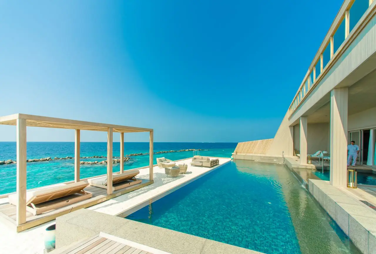 Home Stunning view of a luxury resort in Maldives with an infinity pool overlooking the ocean.